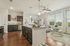 Elegant open-concept apartment with modern kitchen, sleek granite countertops, and a cozy living area filled with natural light.