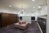 Modern apartment mailroom with sleek lockers, stylish seating, and contemporary lighting.
