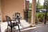 Charming outdoor patio with elegant wrought iron furniture, perfect for relaxing and enjoying scenic views.