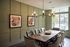 Elegant dining area with a stylish chandelier, modern artwork, and plush seating offering a perfect blend of comfort and sophistication, with natural light flooding through large windows.