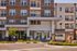 Charming apartment building exterior showcasing modern design with inviting balconies, lush landscaping, and a welcoming entrance, perfect for a vibrant community lifestyle.