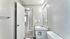 Gray-toned bathroom with modern lighting and updated vanity.