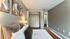 Cozy and stylish bedroom with modern abstract art, plush bedding, and ample closet space.