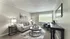 Bright and inviting living room with a cozy sofa, modern decor, and large window for natural light.