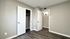 Bright and inviting room with elegant wood flooring, fresh paint, and ample closet space, perfect for modern living.