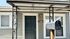 Charming front entry with elegant metal accents, inviting dark door, and welcoming porch, ideal for serene suburban living.