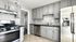 Modern kitchen with sleek stainless steel appliances, elegant gray cabinetry, and generous counter space for a stylish and functional cooking experience.