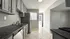 Elegant kitchen with modern dark countertops, sleek stainless steel appliances, and ample cabinetry, offering a bright and inviting space.