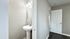 Chic bathroom with modern pedestal sink and elegant wall lighting in a sophisticated, neutral palette.
