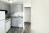 Modern kitchen with sleek cabinetry, dual sink, and bright natural light