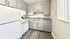 Modern kitchen with sleek gray cabinetry, spacious countertops, and elegant flooring, perfect for culinary adventures.