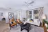 Modern living room with stylish decor, featuring a comfortable beige sofa, chic patterned curtains, and elegant lighting for a cozy atmosphere.