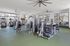 Modern fitness center with state-of-the-art exercise equipment and large windows for natural light.Amenity building located at 1800 Santa Carolina Road in Chula Vista, California.