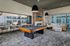 Luxurious apartment lounge with modern pool table, sleek fireplace, plush seating, and expansive windows offering stunning views.Amenity building located at 1800 Santa Carolina Road in Chula Vista, California.