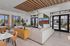 Sophisticated private clubhouse featuring modern decor, spacious seating area, chic marble-topped tables, and abundant natural light from large windows.Amenity building located at 1800 Santa Carolina Road in Chula Vista, California.