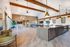 Contemporary open-concept community room featuring a modern kitchen, sleek lighting, and ample seating area with stylish decor.