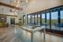 Luxurious apartment with an inviting lounge area featuring a stylish pool table and expansive glass doors opening to scenic views.