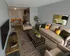 Modern living room with sofa, accent chairs, and coffee table connected to dining area and kitchen at Winchester Arms apartments in Dover, New Hampshire