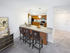 Well-appointed kitchen at Grassfields Commons in Dracut, Massachusetts featuring warm wood cabinetry, modern appliances, and a spacious breakfast bar with comfortable seating for casual dining