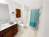 Clean and functional bathroom at Grassfields Commons in Dracut, Massachusetts featuring a walk-in shower, spacious vanity, and neutral finishes