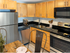 Modern apartment kitchen with stainless steel appliances at Aladdin Village in Derry, NH