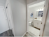 Bright apartment bathroom with modern vanity and mirror at Aladdin Village in Derry, NH