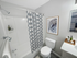 Bright apartment bathroom with tub and shower and modern finishes at Aladdin Village in Derry, NH