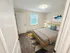 Cozy bedroom with natural light, soft carpet flooring, and modern furnishings at Westgate Arms apartments in Salem, New Hampshire