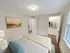 Spacious bedroom with large window, walk-in closet, and soft carpet flooring at Westgate Arms apartments in Salem, New Hampshire