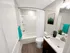 Modern bathroom with tub and shower, vanity sink, and wood-style flooring at Westgate Arms apartments in Salem, New Hampshire