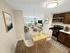 Open-concept kitchen and living area with dining table, modern appliances, and natural light at Westgate Arms in Salem, New Hampshire