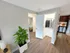 Apartment entryway with coat closet, wood-style flooring, and view into kitchen and bedroom at Westgate Arms in Salem, New Hampshire