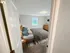 Cozy bedroom with large window, natural light, and plush carpeting in a staged apartment at Westgate Arms in Salem, New Hampshire