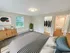 Bright bedroom with large window, walk-in closet, and soft carpet flooring at Westgate Arms apartments in Salem, New Hampshire