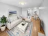 Open concept living room and dining area with hardwood-style flooring and modern finishes at Westgate Arms in Salem, New Hampshire