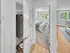 Bedroom with closet space and large windows providing natural light in a staged apartment at Westgate Arms in Salem, New Hampshire