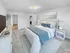 Spacious bedroom with plush carpeting, large bed, and ample closet space in a staged apartment at Westgate Arms in Salem, New Hampshire