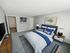 Bedroom at Hamilton Park in Methuen, Massachusetts featuring a spacious layout, neutral carpeting, ample wall space, and direct access to the main living area