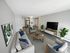 Open-concept apartment at Hamilton Park in Methuen, Massachusetts featuring a spacious living area that connects directly to the kitchen and dining space, with updated flooring and a practical layout for everyday living