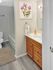 Bathroom with vanity, wood cabinetry, and tub-shower combination at Meadowbrook Village in Gardner, Massachusetts
