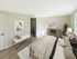 Bedroom with carpeted flooring, closet access, and natural light at Meadowbrook Village in Gardner, Massachusetts