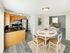 Open kitchen with breakfast bar, stainless steel appliances, and dining area leading to living room at Meadowbrook Village in Gardner, Massachusetts