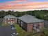 Aerial view of Hamilton Park in Methuen, Massachusetts featuring brick apartment buildings with private balconies and on-site parking