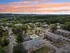 Aerial view of Manchester Gardens in Manchester, New Hampshire showing multiple apartment buildings, parking areas, landscaped grounds, and a central pool area within the community