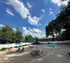 Inviting outdoor pool area with elegant seating and vibrant umbrellas under a clear blue sky, perfect for relaxation.