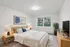 Inviting bedroom with soft neutral tones, large window views, and warm wood furnishings at Derry Country Club Estates in Derry, NH, creating a calm and restful retreat