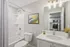 Fresh and thoughtfully designed bathroom with sleek white vanity, curved shower rod, and contemporary lighting at Derry Country Club Estates in Derry, NH, offering a polished and relaxing everyday space