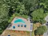 Seasonal swimming pool with lounge chairs and patio seating at Woodlands at Nashua apartments
