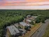Aerial view of Woodlands at Nashua apartments surrounded by trees near Daniel Webster Highway in Nashua, NH