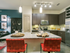 Modern kitchen with pendant lighting, island, wine rack, stainless steel appliances and concrete flooring